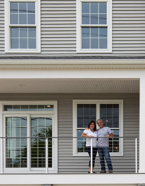 Nancy and Tony in Front of Custom Home